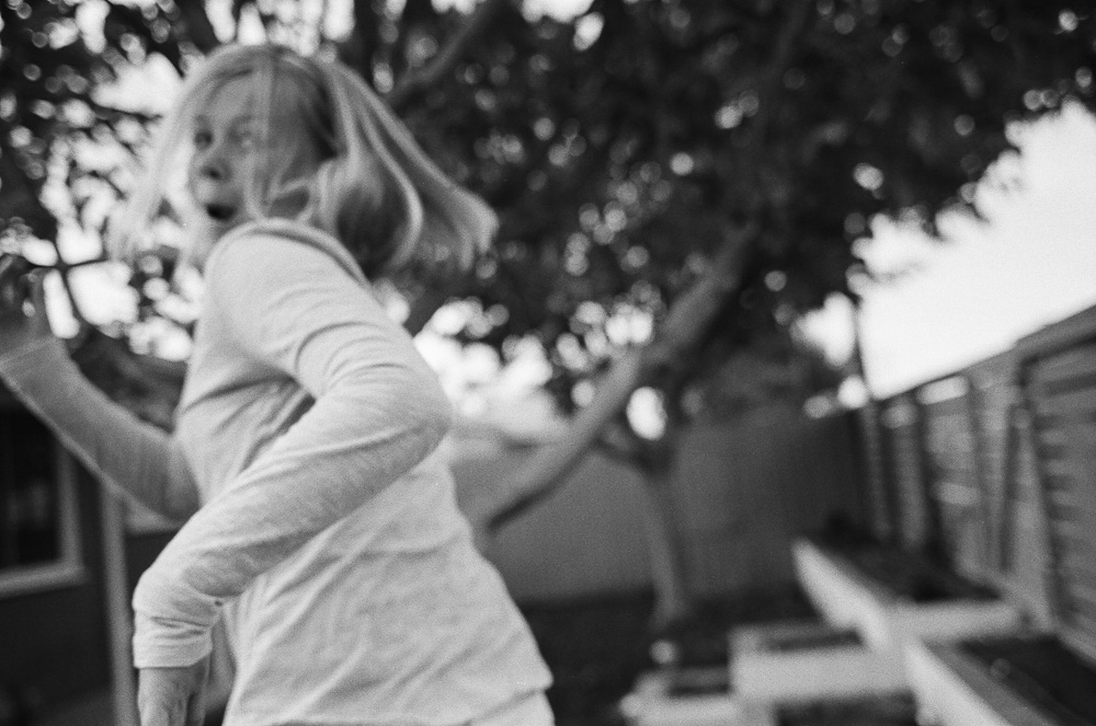 Action shot of young girl (Kate) running from the camera. ©William Bay Photographic Arts.