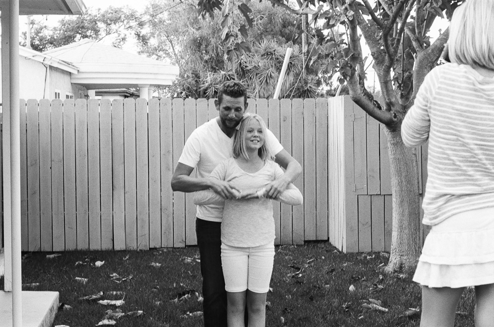Dad (Jeff), and daughter (Kate) goof around while Alex takes a photo. ©William Bay Photographic Arts.